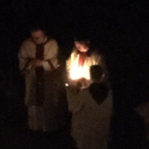 Das Licht der Osterkerze wird weiter gegeben, so dass es in der Kirche immer heller wird. © Erzabtei