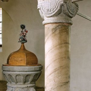 romanische Mamorsäule, im Hintergrund das Taufbecken